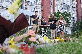 Lviv residents bring flowers to murder site of Iryna Farion