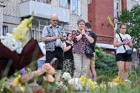 Lviv residents bring flowers to murder site of Iryna Farion