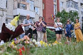 Lviv residents bring flowers to murder site of Iryna Farion