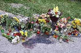 Lviv residents bring flowers to murder site of Iryna Farion