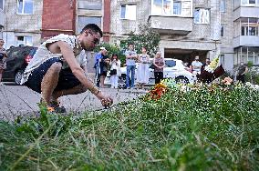 Lviv residents bring flowers to murder site of Iryna Farion