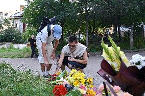 Lviv residents bring flowers to murder site of Iryna Farion