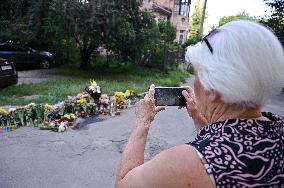 Lviv residents bring flowers to murder site of Iryna Farion