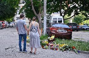 Lviv residents bring flowers to murder site of Iryna Farion