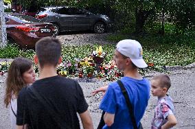 Lviv residents bring flowers to murder site of Iryna Farion