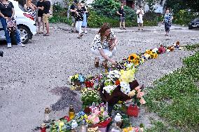 Lviv residents bring flowers to murder site of Iryna Farion