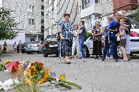 Lviv residents bring flowers to murder site of Iryna Farion