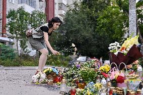 Lviv residents bring flowers to murder site of Iryna Farion