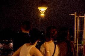 The Cauldron With The Olympic Flame Lit Flies Over Paris