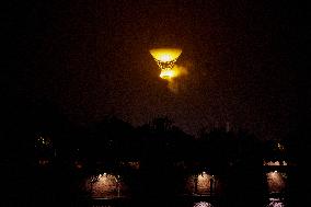 The Cauldron With The Olympic Flame Lit Flies Over Paris