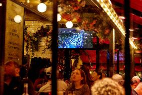 People In The Pub Watching On TV The Opening Ceremony Of The Paris 2024 Olympic Games