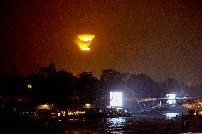 The Cauldron With The Olympic Flame Lit Flies Over Paris