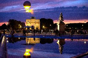 The Cauldron With The Olympic Flame Lit Flies Seen From The Louvre