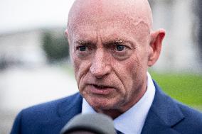 Potential Vice President nominee Sen. Mark Kelly speaks with reporters outside the Capitol