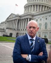 Potential Vice President nominee Sen. Mark Kelly speaks with reporters outside the Capitol