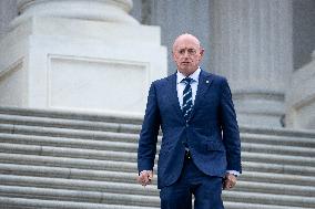 Potential Vice President nominee Sen. Mark Kelly speaks with reporters outside the Capitol