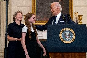 U.S. President Joe Biden stands with hostage familes the White House