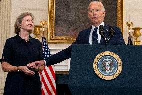 U.S. President Joe Biden stands with hostage familes the White House