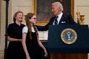 U.S. President Joe Biden stands with hostage familes the White House