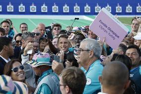 Emmanuel Macron meets volonteers during archery competitions at Invalides