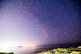 Milky Way Above a Light-Polluted Area