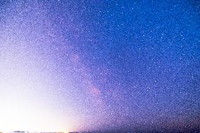 Milky Way Above a Light-Polluted Area