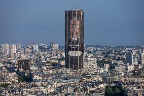 Paris 2024 - Giant Image Of Superstar Leon Marchand Diplayed On The Tour Montparnasse