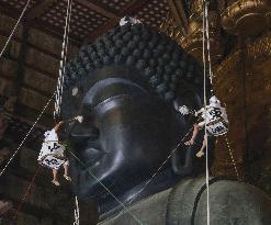 Annual cleaning of Great Buddha of Nara