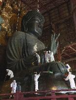 Annual cleaning of Great Buddha of Nara