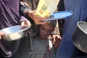 Palestinians Receive Food Rations Amid Conflict