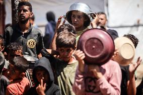 Palestinians Receive Food Rations Amid Conflict