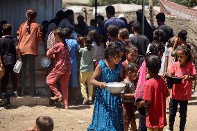 Palestinians Receive Food Rations Amid Conflict