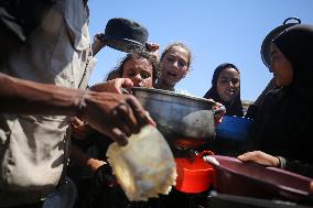 Palestinians Receive Food Rations Amid Conflict