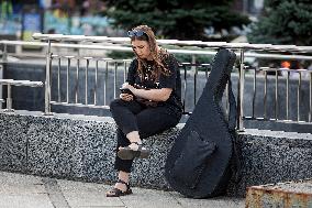 People using smartphones in Kyiv streets