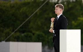 Paris 2024 - Leon Marchand Carries Olympic Flame At Closing Ceremony