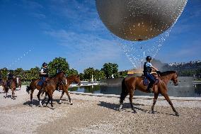 Paris 2024 - Mounted Policemen Pose Next To The Olympic Cauldron