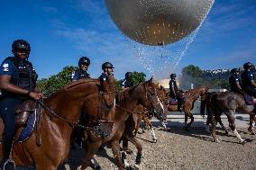 Paris 2024 - Mounted Policemen Pose Next To The Olympic Cauldron