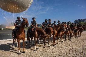 Paris 2024 - Mounted Policemen Pose Next To The Olympic Cauldron