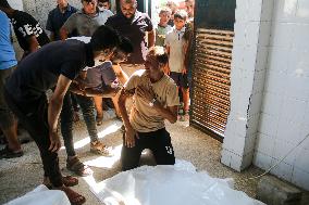 A Palestinian Mourns During Funeral of His Children - Deir al-Balah