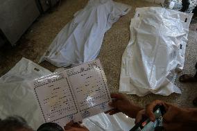 A Palestinian Mourns During Funeral of His Children - Deir al-Balah