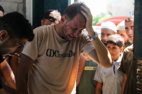 A Palestinian Mourns During Funeral of His Children - Deir al-Balah