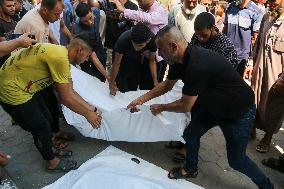 A Palestinian Mourns During Funeral of His Children - Deir al-Balah