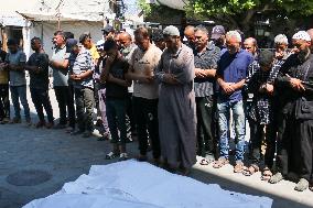 A Palestinian Mourns During Funeral of His Children - Deir al-Balah