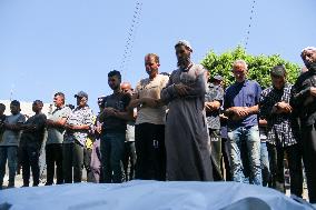 A Palestinian Mourns During Funeral of His Children - Deir al-Balah