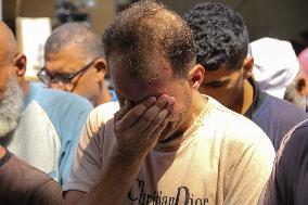 A Palestinian Mourns During Funeral of His Children - Deir al-Balah