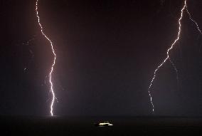 Lightning falls in front of the port of Barcelona