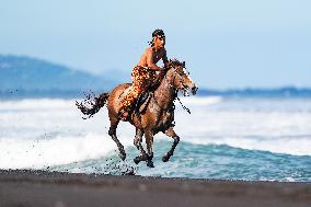 Horse Riders Perform At The Komune Beach In Bali