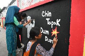 Students Are Painting Graffiti On A Wall Alongside A Road In Dhaka.