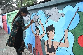 Students Are Painting Graffiti On A Wall Alongside A Road In Dhaka.