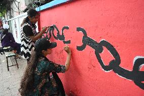 Students Are Painting Graffiti On A Wall Alongside A Road In Dhaka.